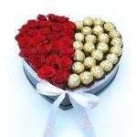 red roses in heart box with chocolates