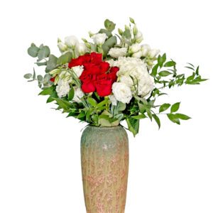 white and red roses in clay vase