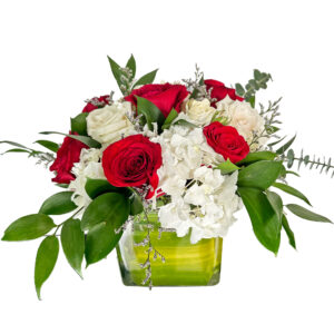 hydrangea and red plus white roses in vase :"corporate flowers"