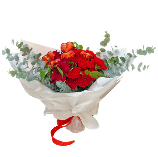 A red bouquet of flowers, wrapped in white and tied with a red ribbon, perfect for Valentine's Day