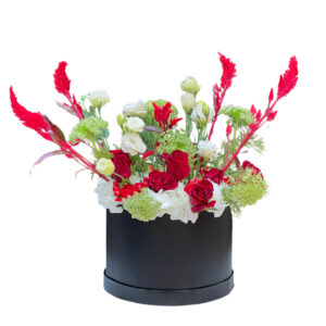 mixed red and white flowers in black round box